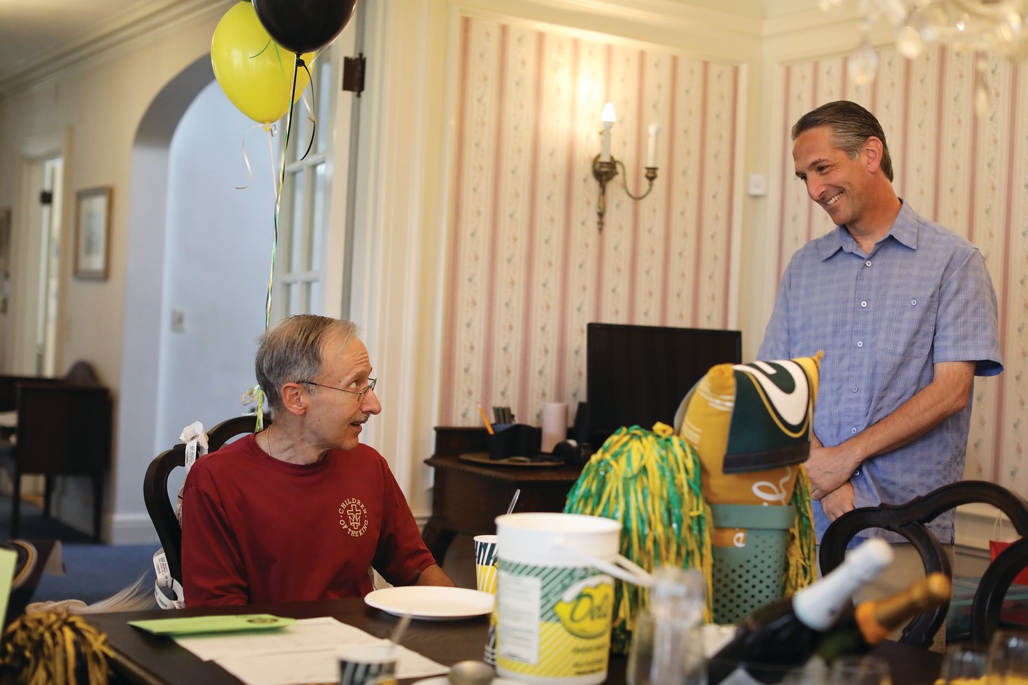 Surrounded by loved ones, Father Raymond Suriani celebrates the end of his cancer treatment.